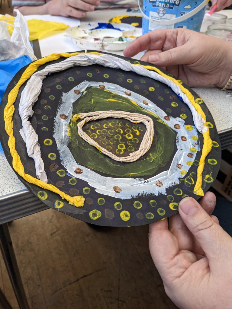 finished rendition of the starry night made with tissue paper and dotted paint.