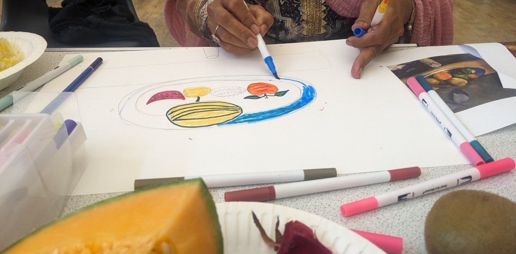 Still life of fruits coloured in markers.