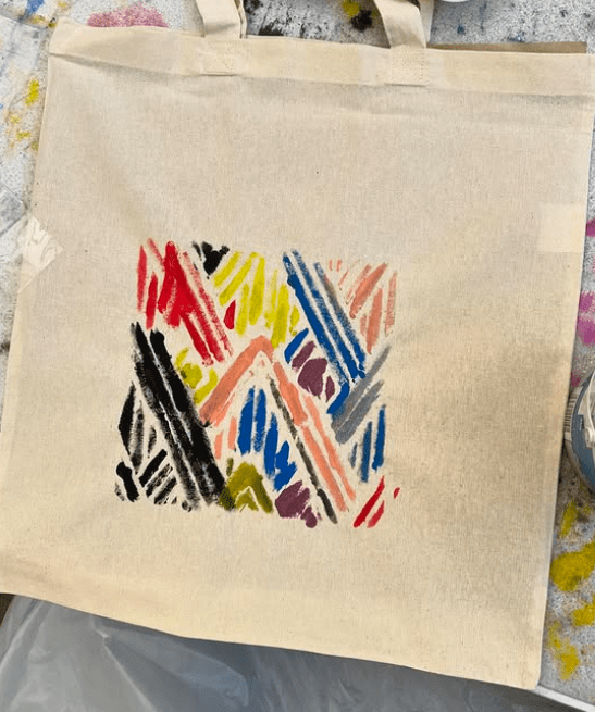 Multicoloured chevron pattern on tote bag.