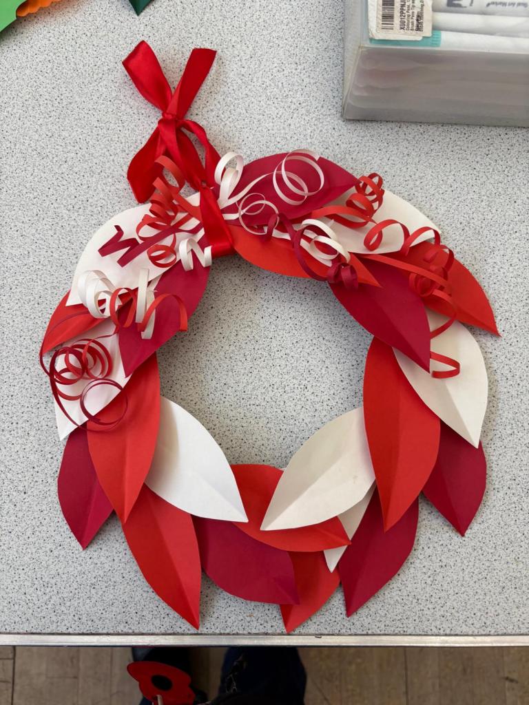 Christmas wreath 3: Has white and red leaves in multiple shades and red and white curled ribbon on the top.