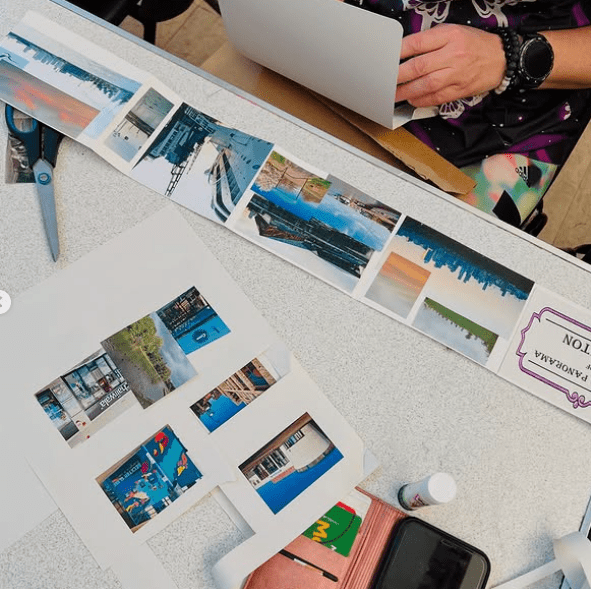 Photo of someone creating their Panorama and a sheet with images being cut out of it.