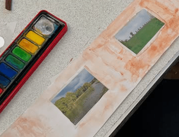 Image of finished panorama. it is painted orange and the photos are of folliage and woodland type places. 